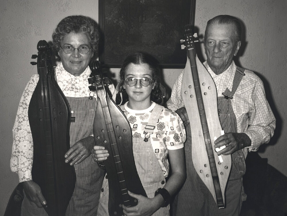 Young Kendra with her parents, Martha and Kenneth Ward, holding dulcimers
